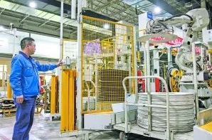 圖:工作人員在5G全連接工廠的成型區(qū)內(nèi)操作機(jī)械手 圖:工作人員在5G全連接工廠的成型區(qū)內(nèi)操作機(jī)械手